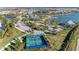 Aerial view of the community pickleball courts next to parking areas and sidewalks in a well landscaped area at 995 Waterline Ct, Sarasota, FL 34240