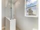 Modern bathroom featuring a glass shower stall and a window with a bright outdoor view at 995 Waterline Ct, Sarasota, FL 34240