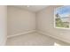 Bright, neutral bedroom with carpet and a window offering a pleasant view of the outdoors at 995 Waterline Ct, Sarasota, FL 34240