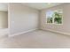 Neutral bedroom with a carpet floor, one window providing natural light and a view of surrounding foliage at 995 Waterline Ct, Sarasota, FL 34240