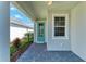The main entrance has a blue door and a gray brick floor at 995 Waterline Ct, Sarasota, FL 34240