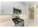Close up of a kitchen with stainless steel oven and microwave, and white cabinets at 995 Waterline Ct, Sarasota, FL 34240