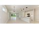 Bright living room features an open floor plan, neutral tones, tile flooring, and a sliding door at 995 Waterline Ct, Sarasota, FL 34240
