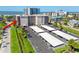 Aerial view of condo building showing parking and proximity to the beach and other buildings at 1001 Benjamin Franklin Dr # 510, Sarasota, FL 34236