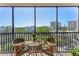 Inviting screened balcony with seating area and views of the lush neighborhood at 1001 Benjamin Franklin Dr # 510, Sarasota, FL 34236