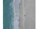 Aerial view of the shoreline where turquoise ocean water meets the soft sand at 1001 Benjamin Franklin Dr # 510, Sarasota, FL 34236