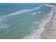 Stunning ocean view with waves gently lapping the shore on a sunny day at 1001 Benjamin Franklin Dr # 510, Sarasota, FL 34236