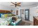Cozy bedroom with unique furniture, a ceiling fan, and connecting bathroom at 1001 Benjamin Franklin Dr # 510, Sarasota, FL 34236