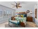 Bright bedroom with unique decor, a ceiling fan, and plantation shutters at 1001 Benjamin Franklin Dr # 510, Sarasota, FL 34236