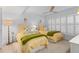 Charming bedroom with twin beds, ceiling fan, and natural light from plantation shutters at 1001 Benjamin Franklin Dr # 510, Sarasota, FL 34236