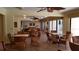 An elegant common room featuring multiple seating areas with ceiling fans and large sliding glass doors at 1001 Benjamin Franklin Dr # 510, Sarasota, FL 34236