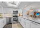 Open kitchen with a large island, stainless appliances, granite counters, and a chandelier at 1001 Benjamin Franklin Dr # 510, Sarasota, FL 34236