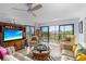 Comfortable living room with balcony access offering plenty of natural light at 1001 Benjamin Franklin Dr # 510, Sarasota, FL 34236