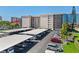 View of the building's parking area, showing parking, and the building beyond at 1001 Benjamin Franklin Dr # 510, Sarasota, FL 34236