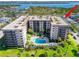 Beautiful pool and lounge area surrounded by lush greenery and palm trees at 1001 Benjamin Franklin Dr # 510, Sarasota, FL 34236