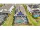 Aerial view of home with solar panels and screened pool, spa, and outdoor seating at 10179 Milky Way Cir, Sarasota, FL 34241