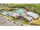 Aerial view of the clubhouse featuring a pool, recreational facilities, and parking at 10179 Milky Way Cir, Sarasota, FL 34241