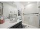 Modern bathroom with a glass-enclosed shower, vanity with sink, and contemporary fixtures at 10179 Milky Way Cir, Sarasota, FL 34241