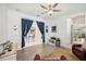 Versatile bonus room with wood floors, a display cabinet, and blue curtains separating it from another space at 10179 Milky Way Cir, Sarasota, FL 34241