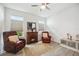 Cozy bonus room with comfortable chairs, a fireplace, and soft lighting, perfect for relaxation at 10179 Milky Way Cir, Sarasota, FL 34241