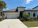 Charming single-story home with a well-manicured lawn, beautiful landscaping, and a two-car garage at 10179 Milky Way Cir, Sarasota, FL 34241