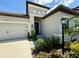 Home's entryway features attractive landscaping and a covered porch area at 10179 Milky Way Cir, Sarasota, FL 34241