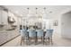 Spacious kitchen island with sink and stainless steel appliances with pendant lighting at 10179 Milky Way Cir, Sarasota, FL 34241