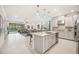 Open-concept kitchen with an island, pendant lighting, and views of the living area and screened-in lanai at 10179 Milky Way Cir, Sarasota, FL 34241