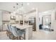 Gourmet kitchen featuring a large island with seating, stainless steel appliances, and bright white cabinets at 10179 Milky Way Cir, Sarasota, FL 34241