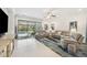 Open living area featuring tile flooring, comfortable seating, and a view of the screened-in pool at 10179 Milky Way Cir, Sarasota, FL 34241