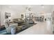 Open-concept living room with neutral tones, tile floors and seamless flow to the kitchen at 10179 Milky Way Cir, Sarasota, FL 34241