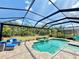 Private screened-in pool and patio area with an unobstructed nature view at 10179 Milky Way Cir, Sarasota, FL 34241