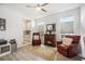 Inviting sitting room features cozy armchairs, a warm fireplace, and natural light from multiple windows at 10179 Milky Way Cir, Sarasota, FL 34241
