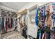 Spacious walk-in closet with organized shelving, hanging racks, and a plush rug at 10179 Milky Way Cir, Sarasota, FL 34241
