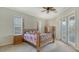 Comfortable bedroom featuring carpet, a ceiling fan, and a 4-poster bed with colorful patterned bedding at 1030 Bahia Vista Ct, Sarasota, FL 34232