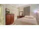 Inviting bedroom with wood furnishings, a floral bedspread, and neutral walls at 1030 Bahia Vista Ct, Sarasota, FL 34232