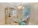 Cozy dining room with a glass-top table, cushioned chairs, and a decorative hutch for storage at 1030 Bahia Vista Ct, Sarasota, FL 34232
