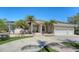 Charming home exterior featuring a three-car garage, tropical landscaping, and a circular driveway for easy access at 1030 Bahia Vista Ct, Sarasota, FL 34232