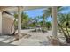Stunning outdoor view framed by architectural pillars, showcasing palm trees and a circular driveway at 1030 Bahia Vista Ct, Sarasota, FL 34232