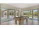 Game room with a pool table and an expansive view of the outdoor pool area through large sliding glass doors at 1030 Bahia Vista Ct, Sarasota, FL 34232