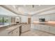 Bright kitchen featuring white cabinets, a breakfast bar, and a seamless flow into the adjacent living spaces at 1030 Bahia Vista Ct, Sarasota, FL 34232
