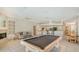 Spacious living area including a pool table, fireplace, and a kitchen with breakfast bar at 1030 Bahia Vista Ct, Sarasota, FL 34232