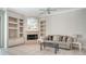 Cozy living room features a decorative fireplace, built-in shelving, and neutral tones to create a relaxing atmosphere at 1030 Bahia Vista Ct, Sarasota, FL 34232