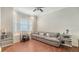 Comfortable living room featuring wood floors, a large sofa, and bright windows with an expansive view at 1030 Bahia Vista Ct, Sarasota, FL 34232