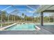 Screened-in pool area featuring clear water, tile coping, and an expansive view at 1030 Bahia Vista Ct, Sarasota, FL 34232