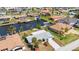 Aerial view of a waterfront home featuring a well-maintained yard, a private dock, and canal access at 108 Peckham Sw St, Port Charlotte, FL 33952