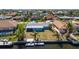 Aerial view of a waterfront property with a private dock and lush landscaping at 108 Peckham Sw St, Port Charlotte, FL 33952