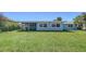 Spacious backyard featuring lush green grass and a charming screened-in porch, perfect for outdoor relaxation at 108 Peckham Sw St, Port Charlotte, FL 33952