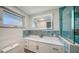 Modern bathroom featuring a vanity with a countertop, LED mirror, and tiled shower at 108 Peckham Sw St, Port Charlotte, FL 33952