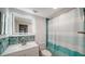 Updated bathroom features a modern lighted mirror, sleek vanity, and stylish tile at 108 Peckham Sw St, Port Charlotte, FL 33952